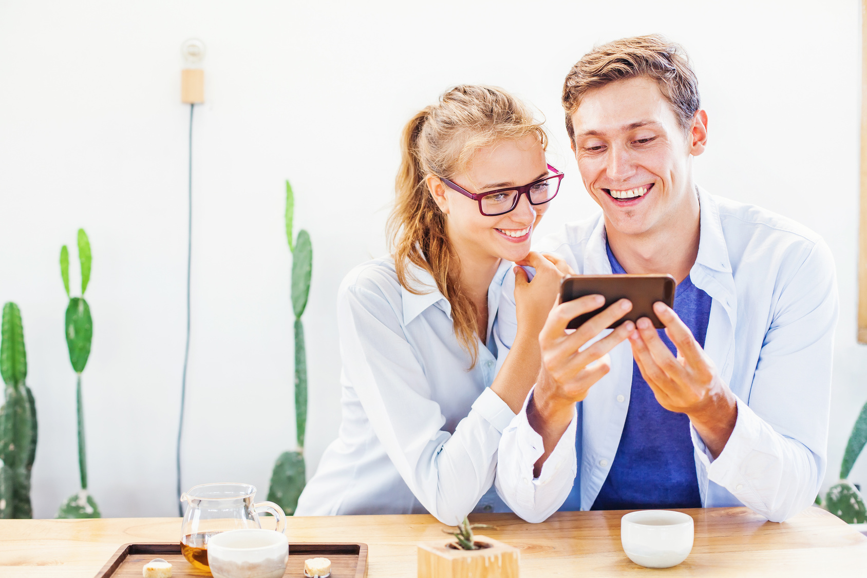 man and woman laughing over phone
